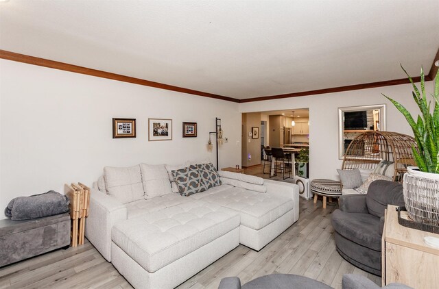 living room with ornamental molding and hardwood / wood-style floors