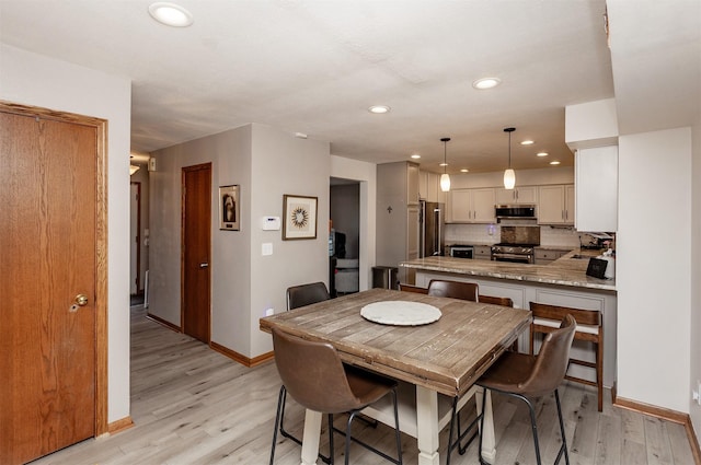 dining space featuring light hardwood / wood-style floors