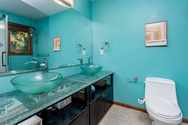 bathroom with vanity, tile patterned floors, and toilet