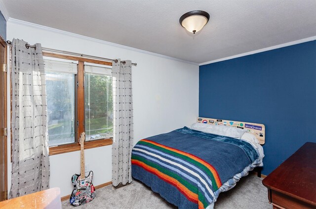 bedroom featuring crown molding and carpet