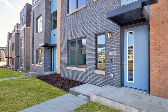 doorway to property featuring a yard