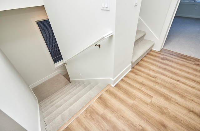 stairway featuring hardwood / wood-style floors