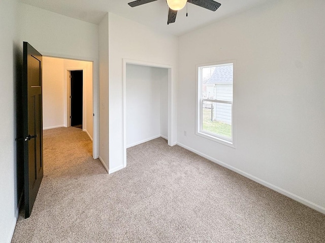 unfurnished bedroom featuring light carpet and ceiling fan