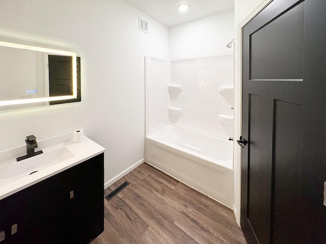 bathroom with vanity, wood-type flooring, and tub / shower combination