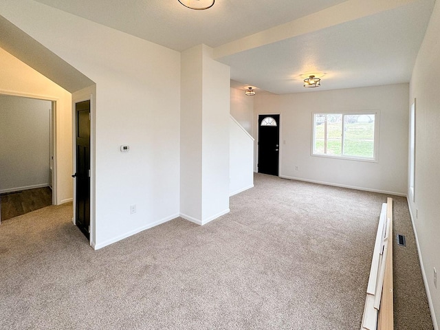 unfurnished room with light colored carpet