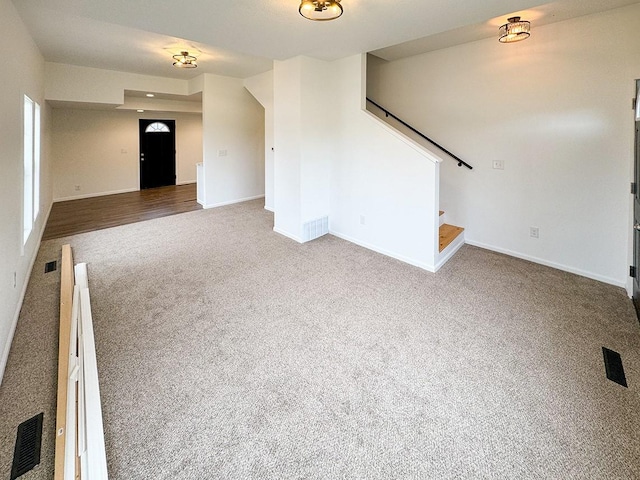 unfurnished living room featuring wood-type flooring