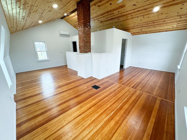 unfurnished living room with hardwood / wood-style flooring, a wall unit AC, wooden ceiling, and high vaulted ceiling