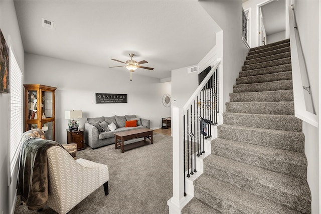 carpeted living room with a wealth of natural light and ceiling fan