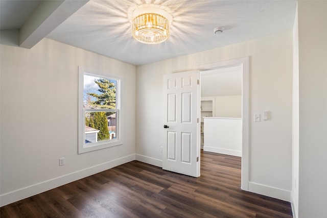 interior space featuring beamed ceiling and dark hardwood / wood-style floors