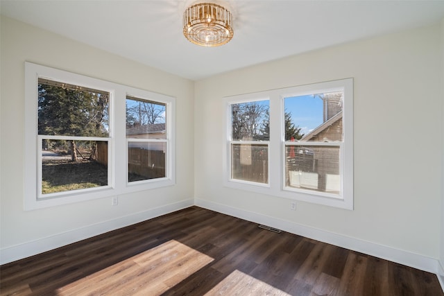 unfurnished dining area with a healthy amount of sunlight and dark wood-type flooring