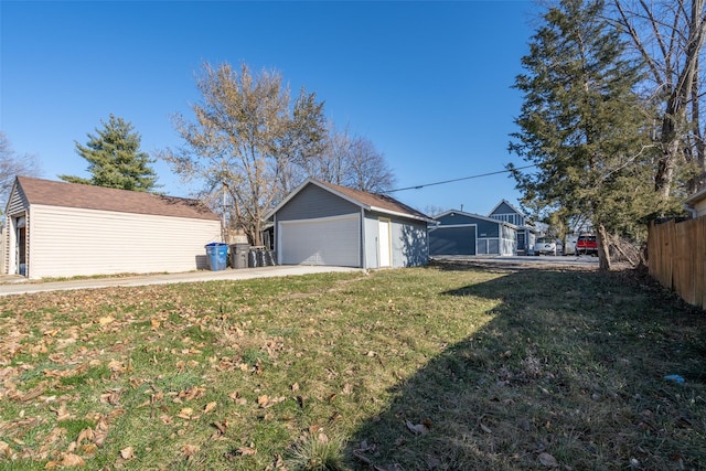 view of yard with a garage and an outdoor structure