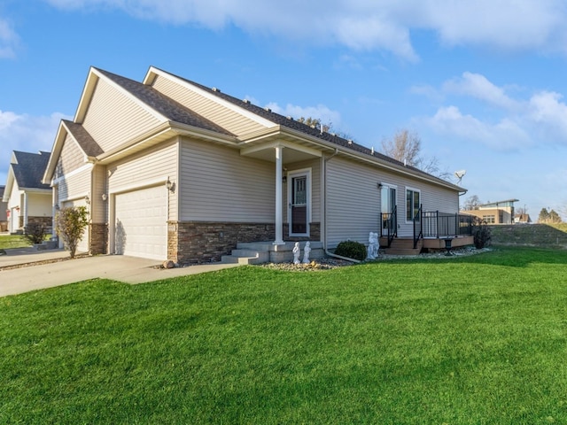 view of front of house featuring a deck, a front yard, and a garage