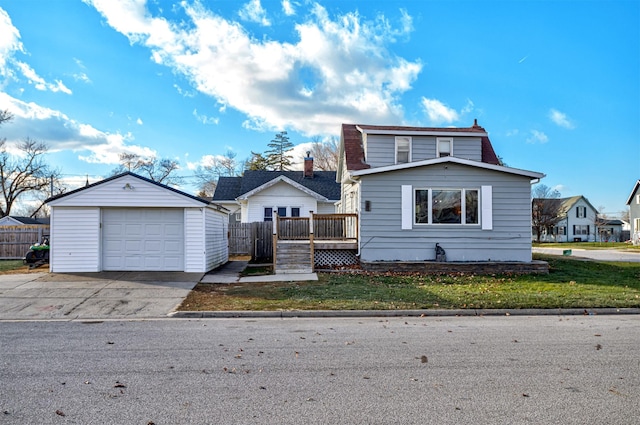 view of front facade with a wooden deck, an outbuilding, a front lawn, and a garage