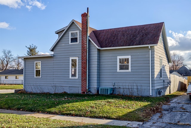 view of home's exterior featuring a yard and cooling unit