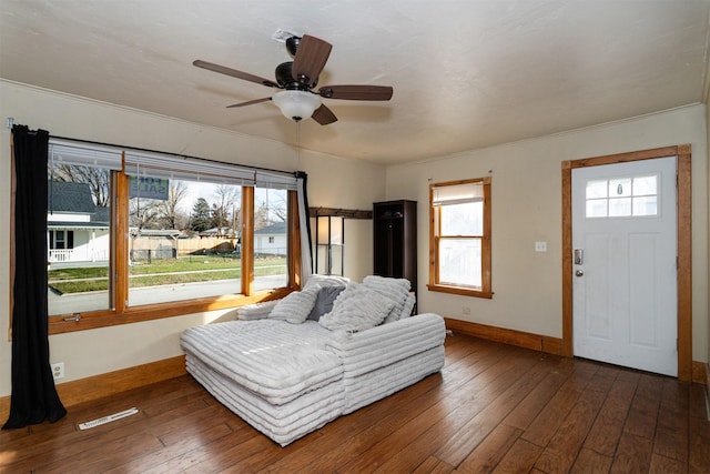 bedroom featuring ceiling fan, dark wood-type flooring, and ornamental molding