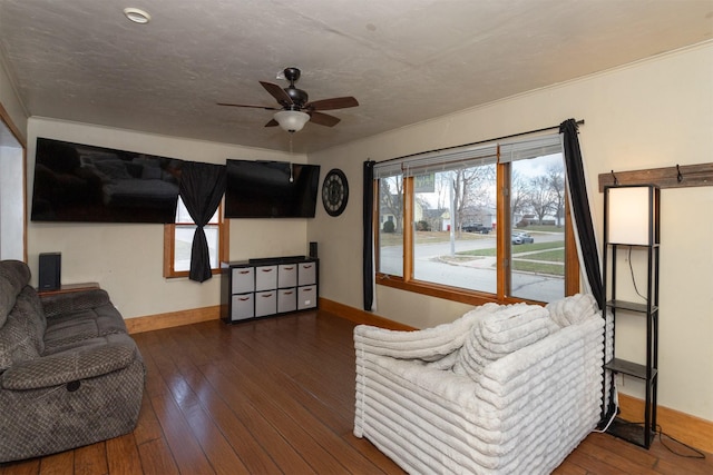 living room with ceiling fan and dark wood-type flooring