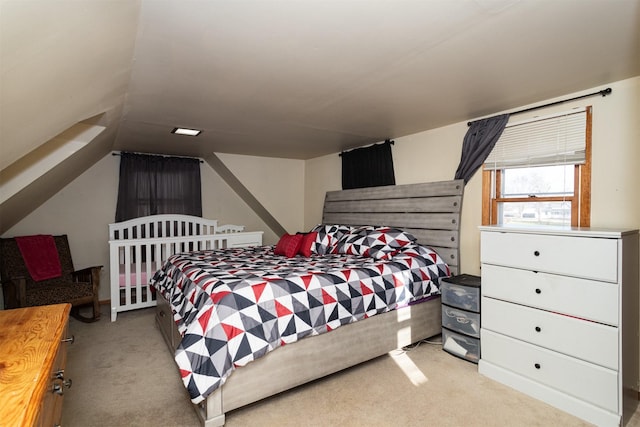 bedroom featuring light carpet and lofted ceiling