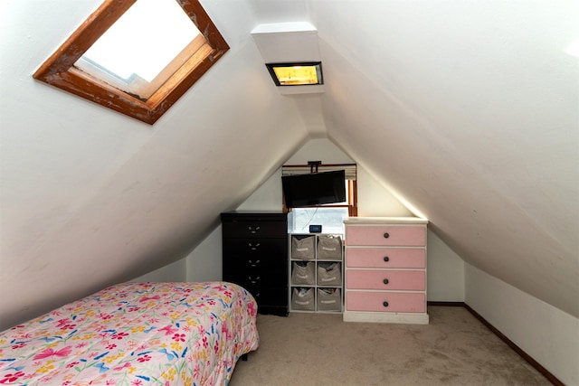 carpeted bedroom with lofted ceiling with skylight