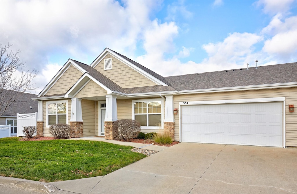 craftsman-style home with a front yard and a garage