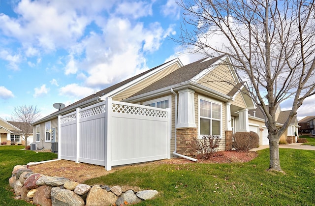 view of side of home with a yard