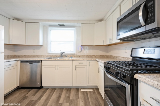 kitchen featuring white cabinetry, dark wood-type flooring, and appliances with stainless steel finishes