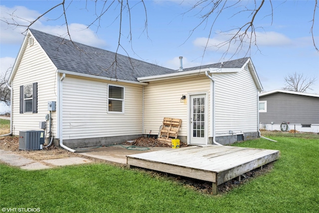 rear view of house featuring a lawn, a wooden deck, and central AC