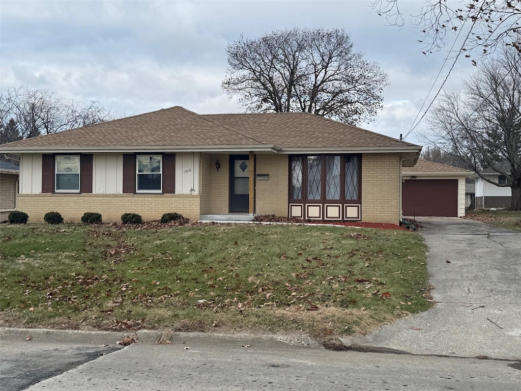 single story home with a garage and a front yard