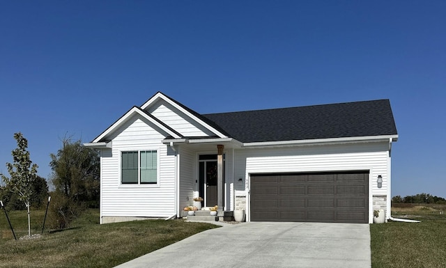 view of front of home featuring a garage and a front yard