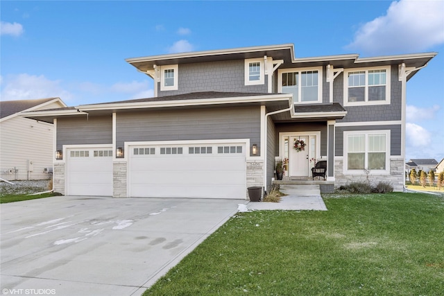 view of front of house with a garage and a front lawn