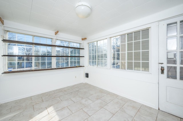 unfurnished sunroom with a wealth of natural light