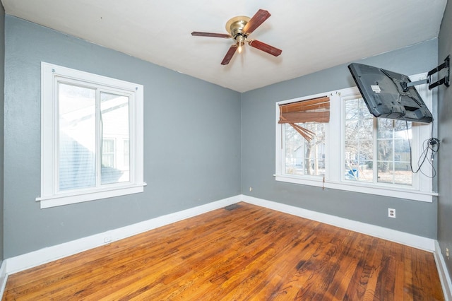 empty room featuring hardwood / wood-style flooring and ceiling fan