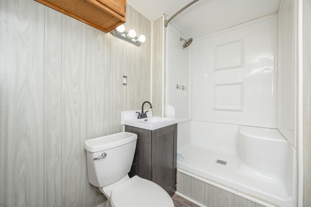 bathroom with vanity, toilet, and a shower