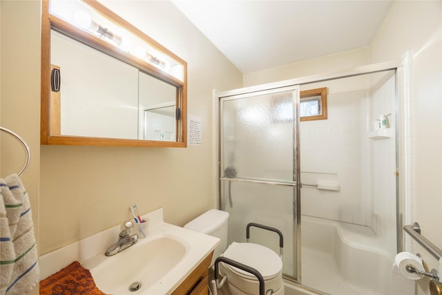 bathroom featuring vanity, toilet, and an enclosed shower