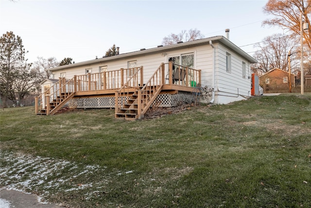 back of property with a yard and a wooden deck