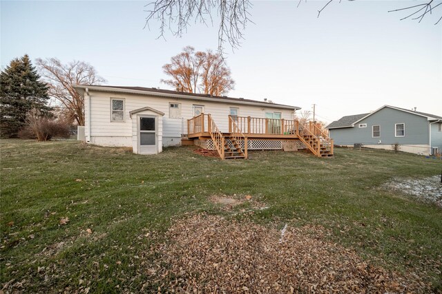 back of house with a yard and a deck