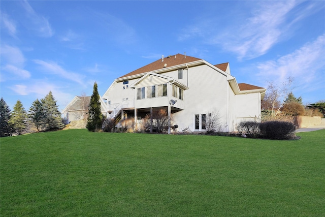 back of property with a lawn and a sunroom