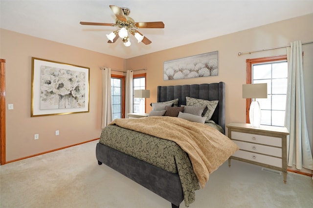 bedroom with ceiling fan and light carpet