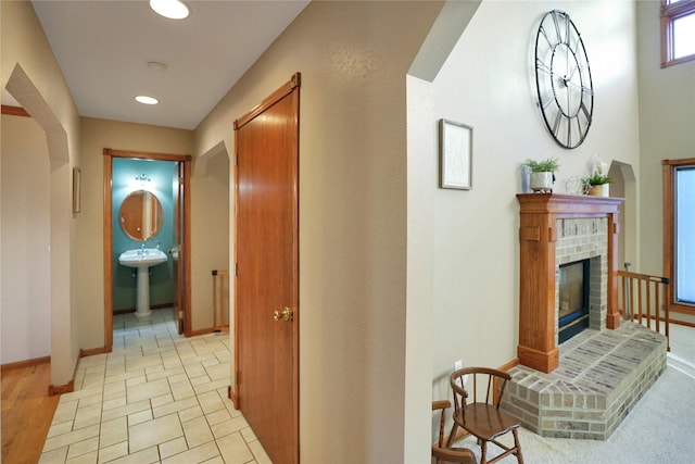 hall featuring light hardwood / wood-style flooring and sink