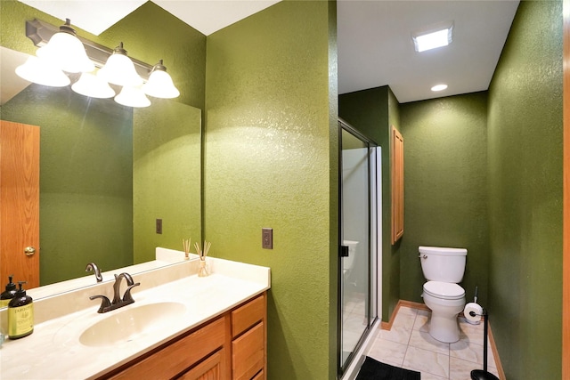 bathroom with tile patterned flooring, vanity, toilet, and a shower with shower door