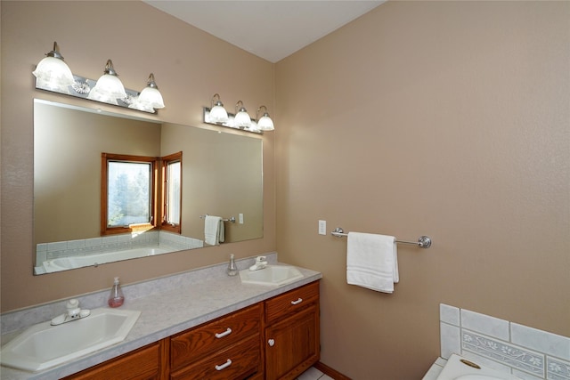 bathroom featuring vanity and a washtub