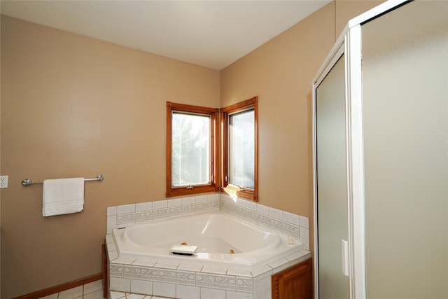 bathroom featuring tile patterned flooring and independent shower and bath