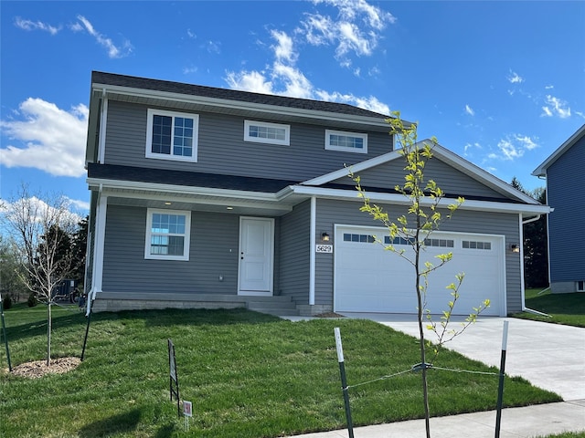 view of front of home with a garage and a front lawn