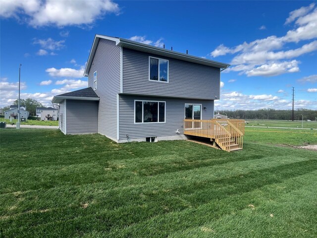 rear view of house with a lawn and a deck