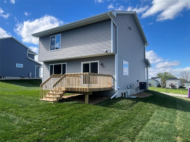 back of house featuring a wooden deck, a yard, and central AC