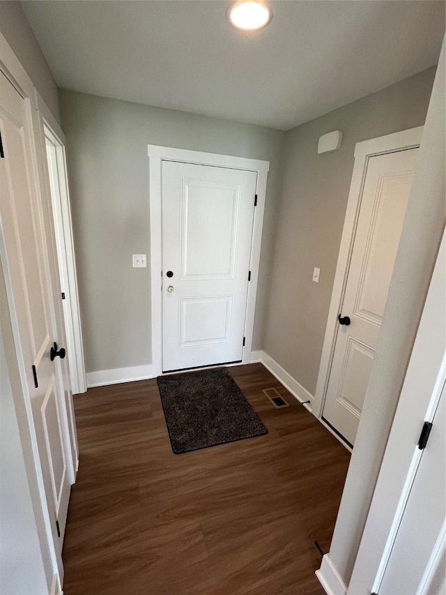 entryway with dark hardwood / wood-style flooring