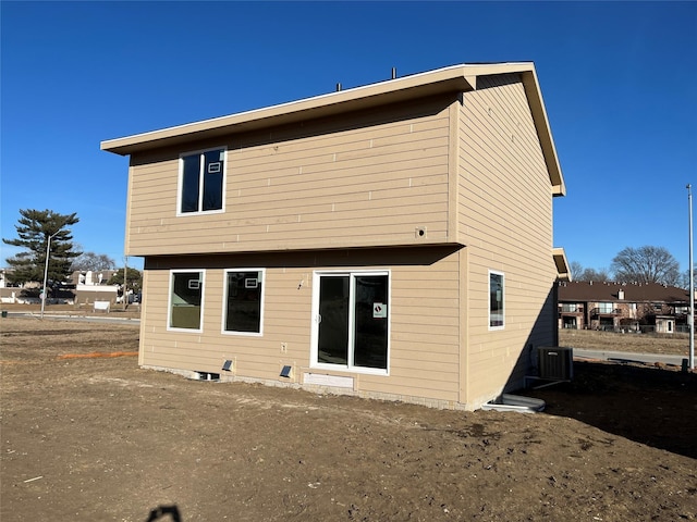 rear view of property featuring central AC unit