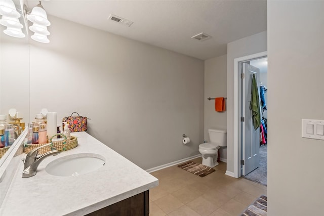 bathroom with tile patterned flooring, vanity, and toilet