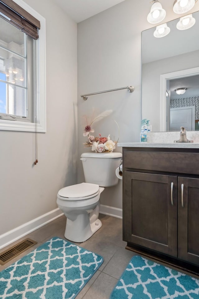 bathroom with tile patterned floors, vanity, and toilet