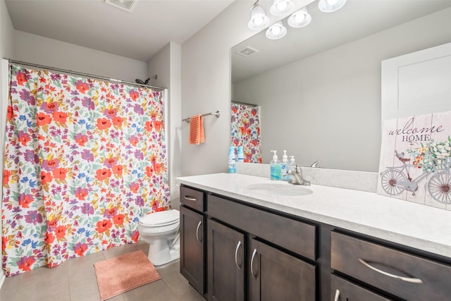 bathroom featuring toilet, vanity, and tile patterned floors