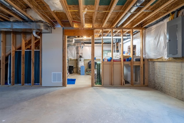 basement with electric panel and gas water heater